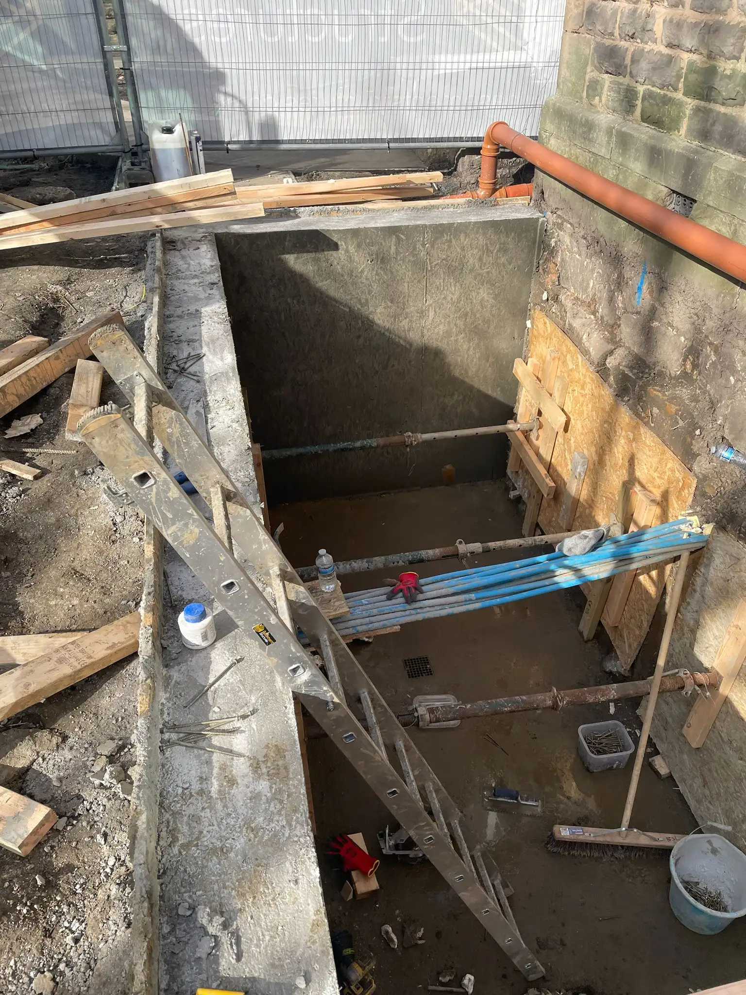 Basement construction logistics and neighbour management